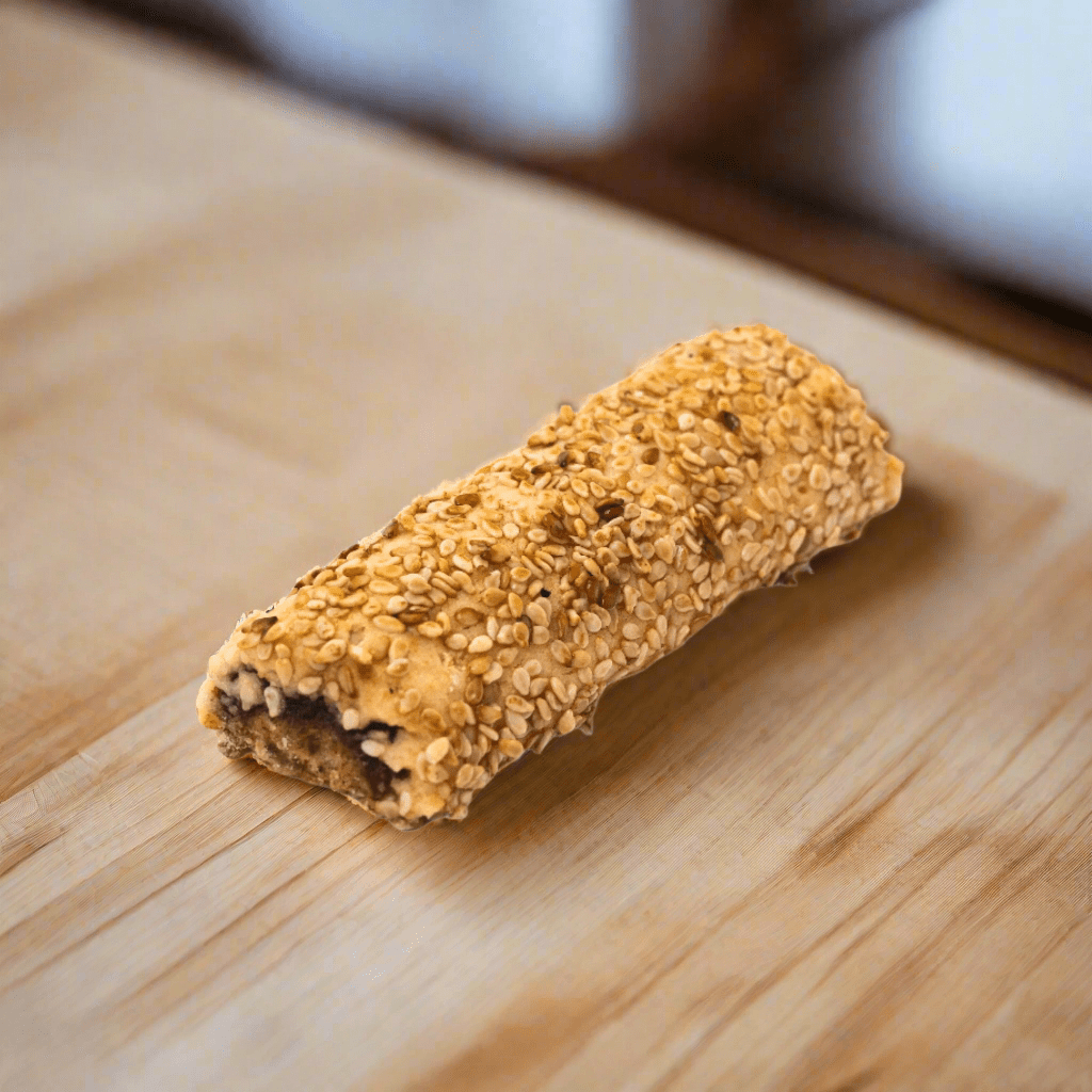 Al-Hamdani Sweets sesame date cookies — close-up showing golden sesame seed crust and date filling